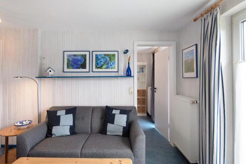 a living room with a couch and a table at Möve Aba Bungalow 63 in Rerik