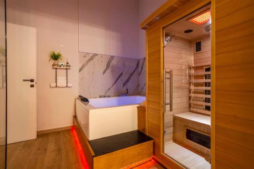 a bathroom with a tub and a walk in shower at Piccolo Incanto Spa Palermo in Palermo