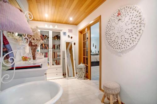 a bathroom with a sink and a mirror at Casa da Mãe Maria in Buarcos