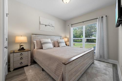 a bedroom with a large bed and a window at Marigold House in Foley