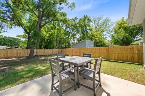 a picnic table with two chairs and a fence at Marigold House in Foley