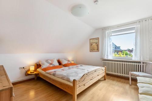 a bedroom with a large bed and a window at Ferienwohnung Flensburg Mürwik in Flensburg