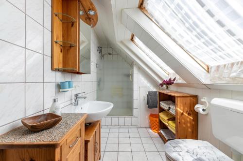a bathroom with a sink and a skylight at Ferienwohnung Flensburg Mürwik in Flensburg