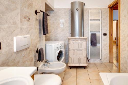 a bathroom with a washing machine and a sink at Premesan 5 in Bormio