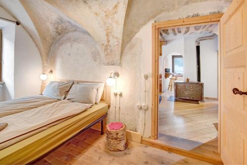 a bedroom with a large bed with a ceiling at Premesan 5 in Bormio