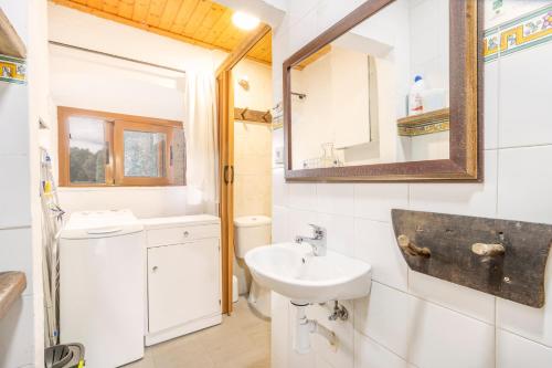 a bathroom with a sink and a mirror at La Caseta De Sant Grau in Navés