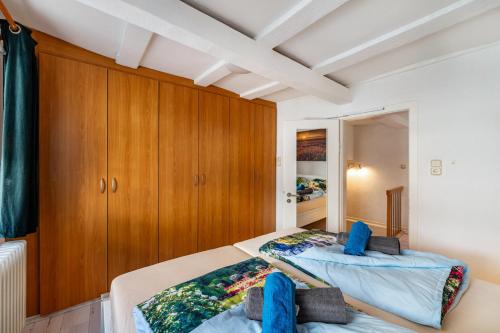 a bedroom with a bed and wooden cabinets at Ferienhaus bei Reichsburg Cochem in Cochem