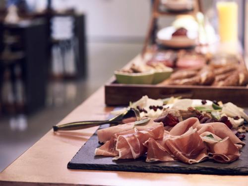 a plate of food on a table with meat at InnAthens in Athens