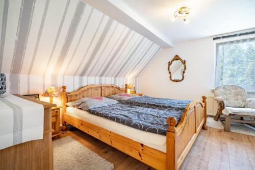 a bedroom with a bed and a chair at Ferienwohnungen in Starsow in Mirow