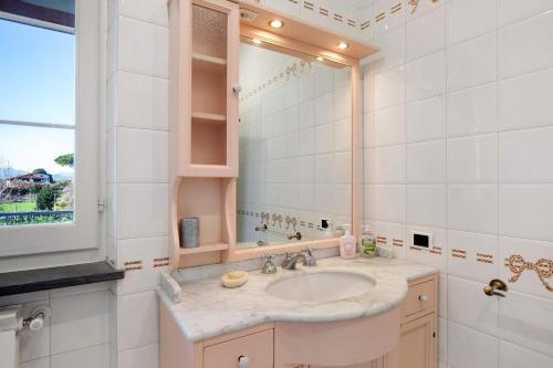 a bathroom with a sink and a mirror at Villa Lucia in Ameglia