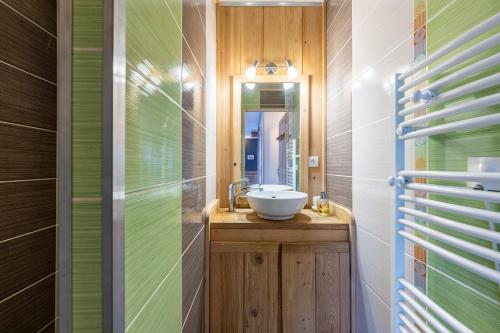 a bathroom with a sink and a mirror at Chalet du Fey in Valmorel