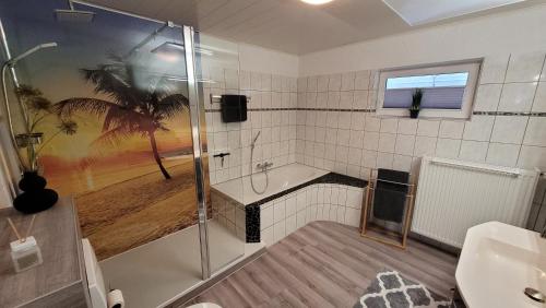 a bathroom with a shower and a toilet and a sink at Ferienwohnung Friedhoff, 80qm in Schmallenberg