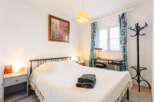 a bedroom with a bed with a table and a desk at Location Oléron, proche plage in Dolus-d'Oléron