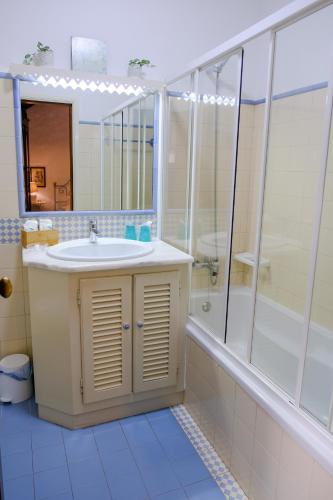 a bathroom with a sink and a shower at Casa do Nato -Turismo Rural in Viana do Castelo