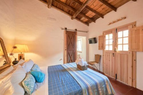 a bedroom with a bed and a chair in it at Casa Bica D'Alva in Vila Alva