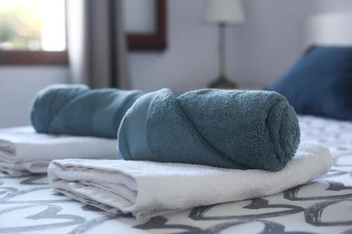 a pile of towels sitting on top of a bed at Sol Isla - Binimar in Arenal d'en Castell