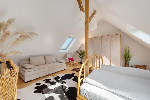 a living room with a bed and a couch at Großzügige Maisonettewohnung in Sindelfingen