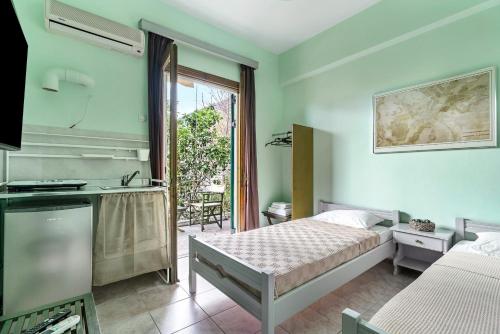 a hotel room with a bed and a balcony at Old Boat double studio 6 in Nikiana