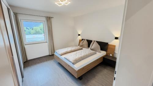 a bedroom with a bed and a window at Ferienhaus Koca in Imsterberg