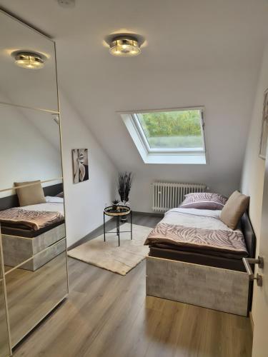 a bedroom with two beds and a window at Neu 4 Zi Kü Bad Coll-mar in Neunkirchen