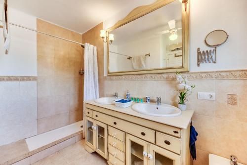 a bathroom with a sink and a mirror at Villa Tessa in Marbella