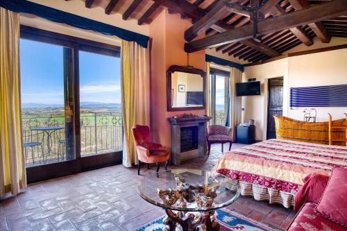 a bedroom with a bed and a large window at Le Buccole Country House in Marsciano