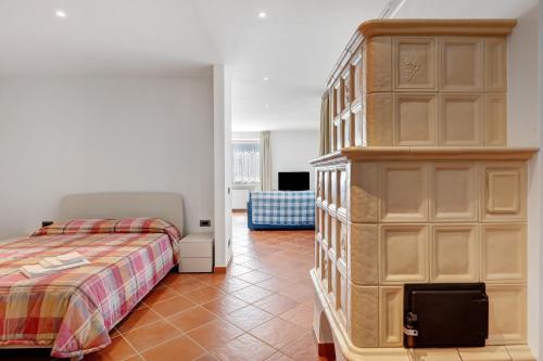 a bedroom with a bed and a large wooden cabinet at Casa Colìn in Bresimo