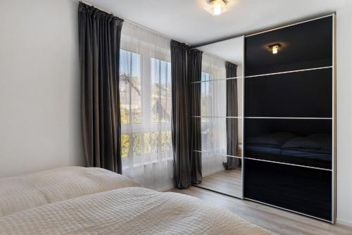 a bedroom with a bed and a large mirror at Caroline Magg in Lindau