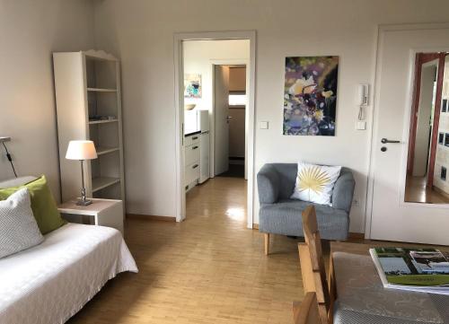 a living room with a couch and a chair at Ferienwohnungen Pano in Friedrichshafen