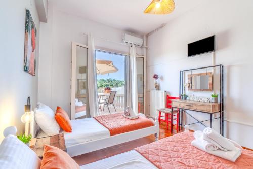 a bedroom with two beds and a mirror at Maestro Apartment in Gaios
