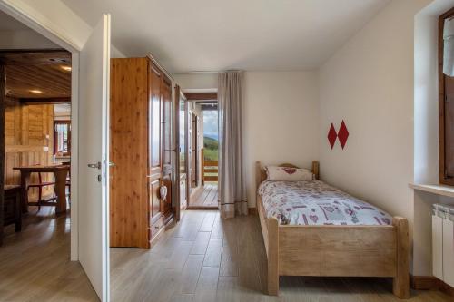 a bedroom with a bed and a dining room at Appartamento Pila Vacanze in Gressan