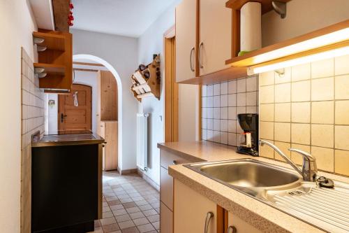 a kitchen with a sink and a counter at Thomasegg Hof Birke in Sarntal