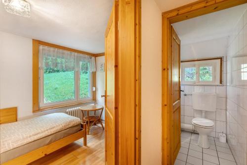 a bedroom with a bed and a toilet and a shower at Hornihäusle in Aufʼm Bühl