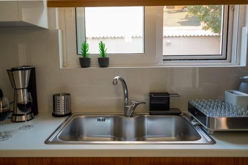 a kitchen counter with a sink and a window at Casa Marjeta in Chania