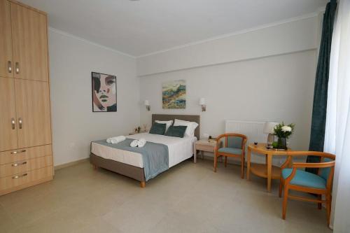 a bedroom with a bed and a table and chairs at Casa Marjeta in Chania