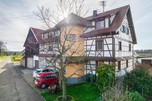 a red truck parked in front of a house at Haus48 in Neuried