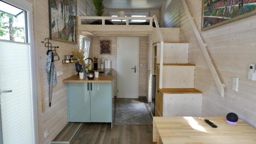 a kitchen and dining area of a tiny house at Tiny House Nr 2 in Schwielowsee