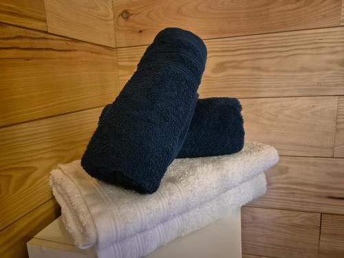 a stack of towels sitting on top of a box at Le Chalet Cocon et Jacuzzi in La Petite-Pierre