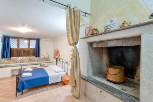 a bedroom with a bed and a fireplace at Meraviglie Salentine - Lecce in Lequile