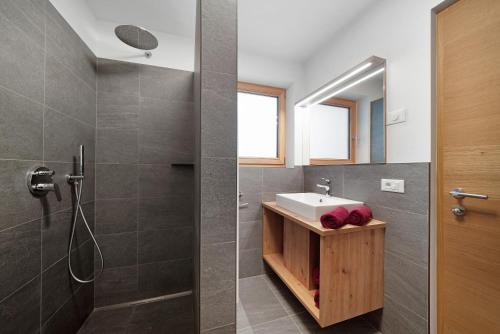 a bathroom with a sink and a shower at Tholerhof in Schenna