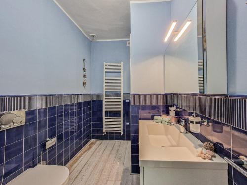 a bathroom with a sink and a toilet and a mirror at Villa Galatea Exclusive in Capoliveri