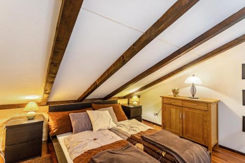 a attic bedroom with a bed and a couch at Ferienhaus Vorauf - Rosenbauer in Siegsdorf