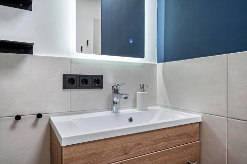 a bathroom with a white sink and a mirror at Ferienbungalow Süssau in Süssau