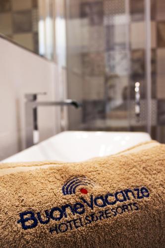 a close up of a towel on a bed at BV Kalafiorita Resort in Zambrone