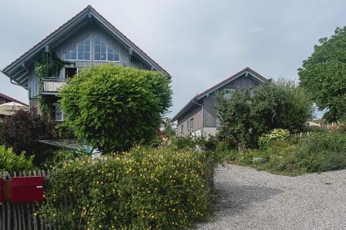 a house with a fence and some bushes and trees at Ferienhof Mrowka in Reutin