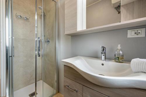 a bathroom with a sink and a shower at My town home apartment in Torri del Benaco