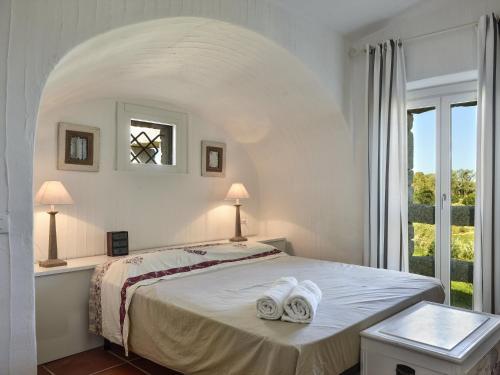 a bedroom with a bed with two towels on it at Li Conchi 13 in Castiadas