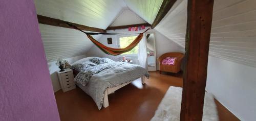 a small bedroom with a bed in a attic at Ferienhaus am Wald in Reichshof 