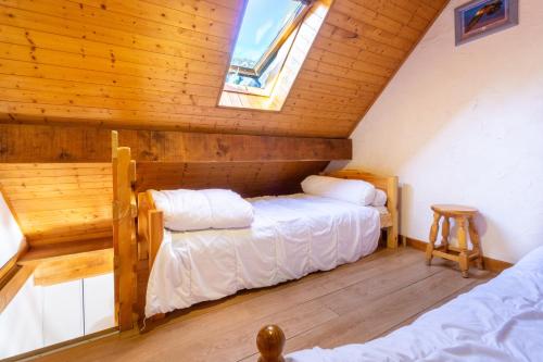 a bedroom with two beds in a attic at Appartement n°10 - 8 personnes in Saint-Sorlin-dʼArves