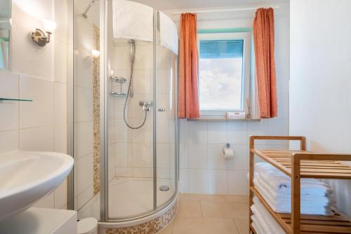 a bathroom with a shower and a sink at Ferienwohnung 3 in Grassau
